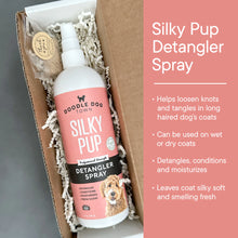 Load image into Gallery viewer, Silky Pup bottle inside gift box with crinkle paper. Right side has pink bar with bullets points about product.
