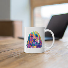 Load image into Gallery viewer, colorful cockpoo white ceramic mug sitting on wooden desk with blurred out laptop behind it

