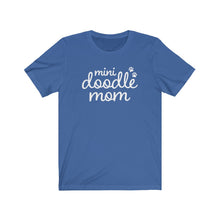 Load image into Gallery viewer, White script cute text that reads "mini doodle mom "with two paws on the right side on a royal blue T-shirt