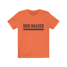Load image into Gallery viewer, black text that reads "dog walker" in a cool Army-like font with A trail of paw prints inside a rectangle underneath the text on orange T-shirt