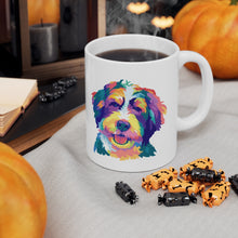 Load image into Gallery viewer, colorful Bernedoodle or Goldendoodle dog pop art illustration on ceramic mug with steaming coffee and Halloween candy in front with pumpkins and black candles behind it
