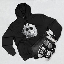 Load image into Gallery viewer, black hoodie sweatshirt lying flat with black and white illustration of goldendoodle dog with black sunglasses. a pair of black jeans and bland and white shoes are lying next to the sweatshirt
