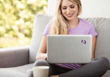 Load image into Gallery viewer, A beautiful blond long-haired girl sitting on gray couch smiling, holding a silver laptop with a colorful bernedoodle dog sticker on the back of laptop