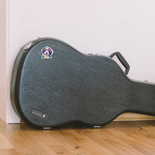Load image into Gallery viewer, Multi-colored small bernedoodle dog sticker stuck on a black guitar case that is sitting on light colored wood floors next to white wall.
