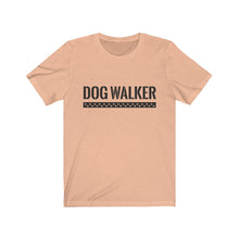 Load image into Gallery viewer, black text that reads "dog walker" in a cool Army-like font with A trail of paw prints inside a rectangle underneath the text on peach T-shirt