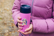 Load image into Gallery viewer, colorful berndoodle sticker on purple thermos mug held by women with purple coat