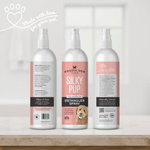 Load image into Gallery viewer, Made with love for your pet written in script by a heart paw graphic in top left. Silky Pup Detangler Spray bottle shown three times, so all sides of label are shown. The bottles are sitting on bathroom counter with white blurred window in background
