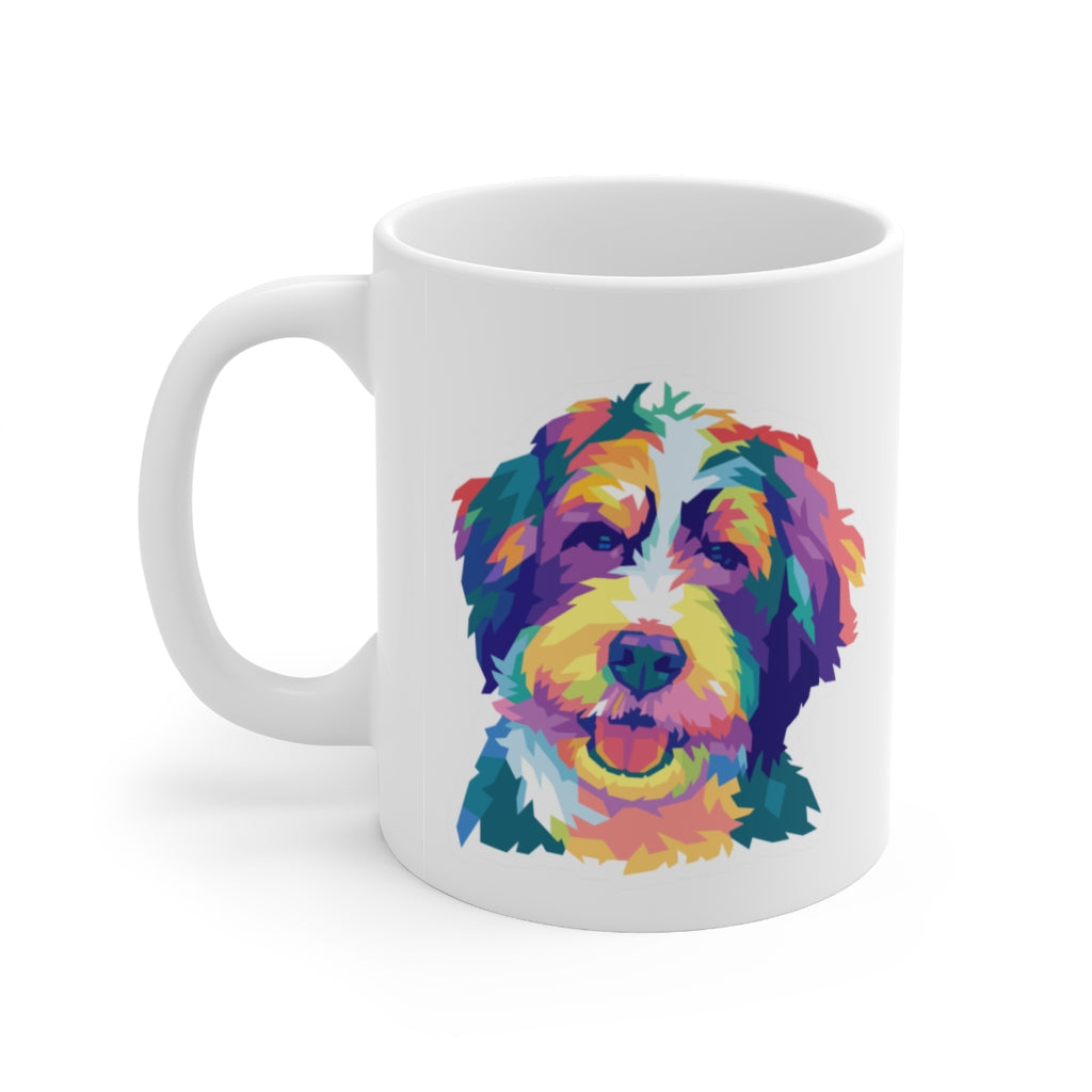 multicolored illustration of a Bernedoodle dog or Goldendoodle dog on a white ceramic mug, handle on left side