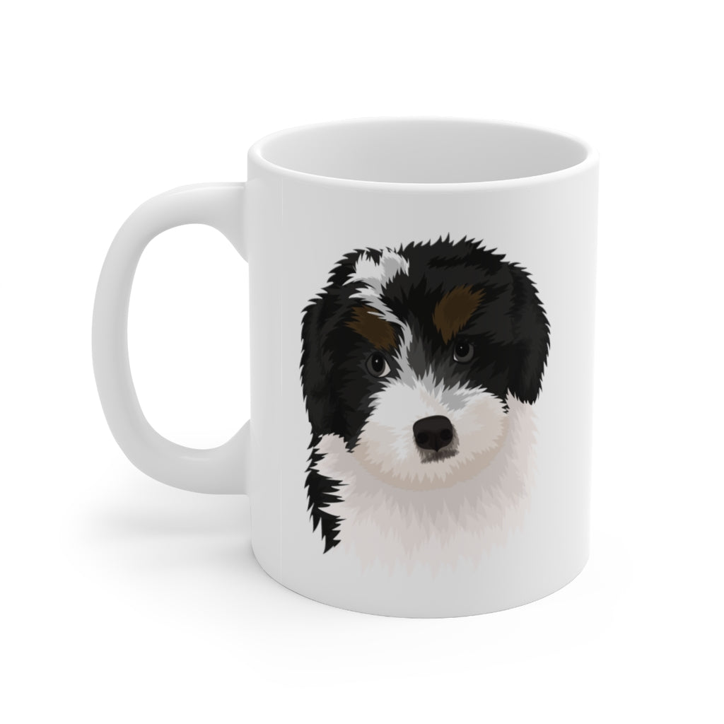 black, white and brown bernedoodle illustration on white mug with handle on left side
