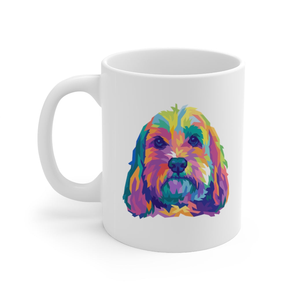 Colorful pop art illustration of doodle dog, perhaps a cockapoo or golden doodle on white ceramic mug with handle on left