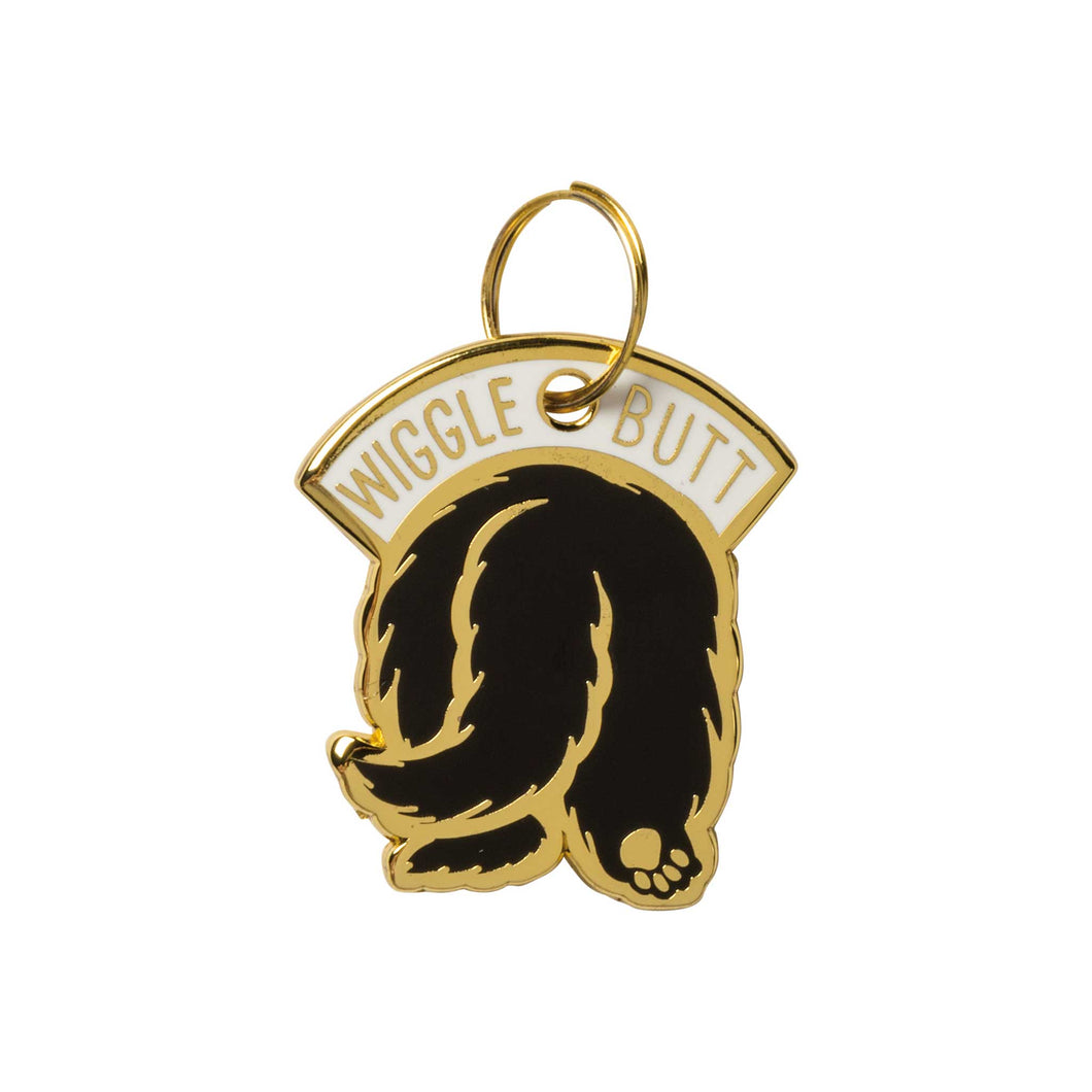 black and gold enamel dog charm that says wiggle butt and shows back of dog's butt and tail  Edit alt text
