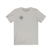 Load image into Gallery viewer, A small black logo of Doodle Dog Town which consists of a circle with the words inside following the shape of the circle with a black silhouette of a doodle dog in the middle on a silver t-shirt
