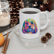 Load image into Gallery viewer, Colorful pop art illustration of doodle dog, perhaps a cockapoo or golden doodle on white ceramic mug with handle on right and coffee steaming from the cup and 2 across and cinnamon stickers with lit candle and string of fairy lights in an overall holiday themed scene
