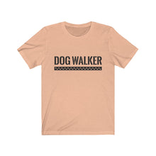 Load image into Gallery viewer, black text that reads &quot;dog walker&quot; in a cool Army-like font with A trail of paw prints inside a rectangle underneath the text on peach T-shirt
