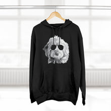 Load image into Gallery viewer, black hoodie sweatshirt with black and white illustration of goldendoodle dog with black sunglasses on front hanging from wood hanger
