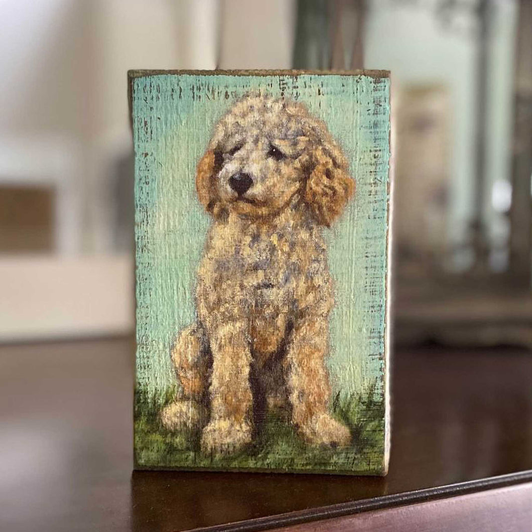 adorable rustic painted goldendoodle dog on a wooden block sitting on wooden mantel